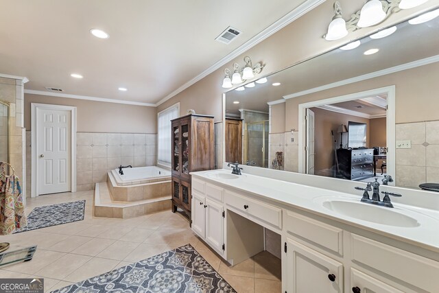 2205 Parliament Dr, Lawrenceville, GA 30043 - bathroom featuring tile patterned floors, double vanity, a garden tub, a stall shower, and tile walls