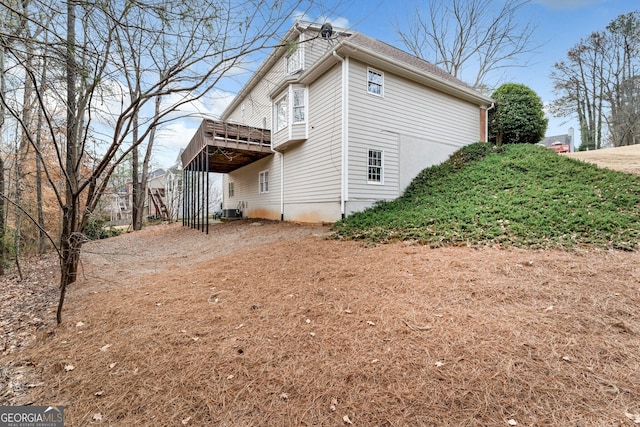 2205 Parliament Dr, Lawrenceville, GA 30043 - view of home's exterior featuring a wooden deck and cooling unit