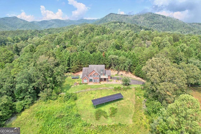 drone / aerial view featuring a mountain view and a wooded view