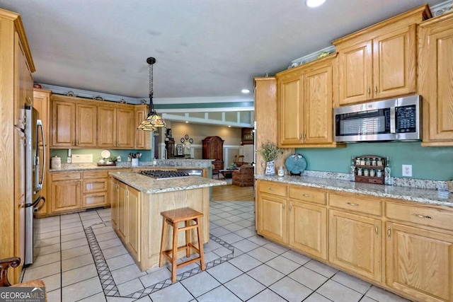 kitchen with light stone countertops, a kitchen island, light tile patterned flooring, recessed lighting, and appliances with stainless steel finishes