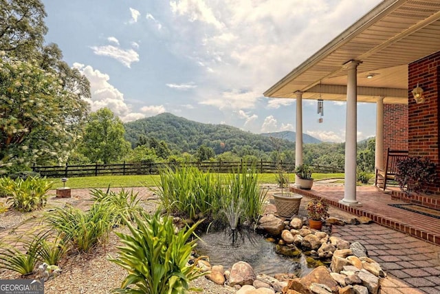 exterior space featuring a mountain view and fence