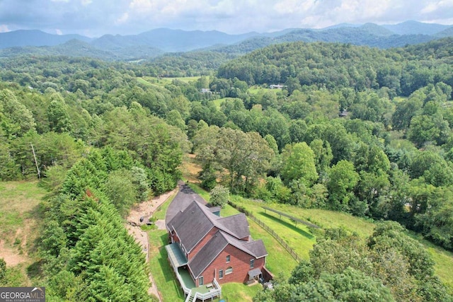 bird's eye view with a mountain view and a wooded view