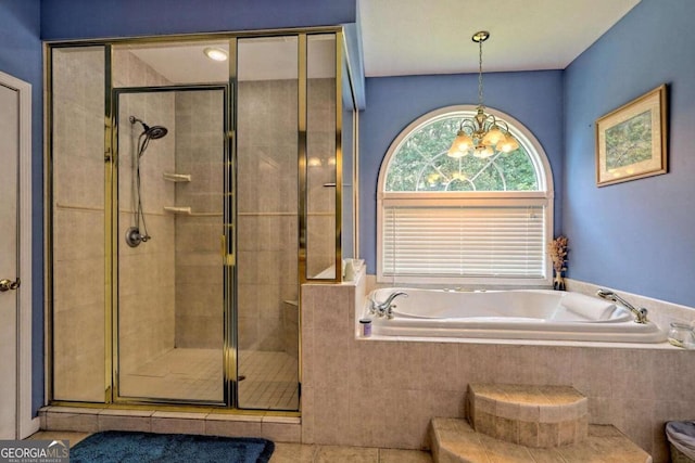 bathroom with tile patterned floors, a notable chandelier, a stall shower, and a bath