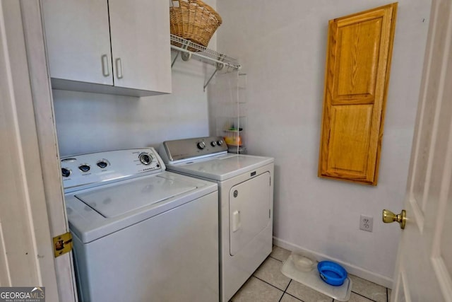 washroom with light tile patterned floors, baseboards, cabinet space, and independent washer and dryer