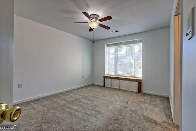 unfurnished bedroom featuring visible vents, baseboards, carpet, and ceiling fan