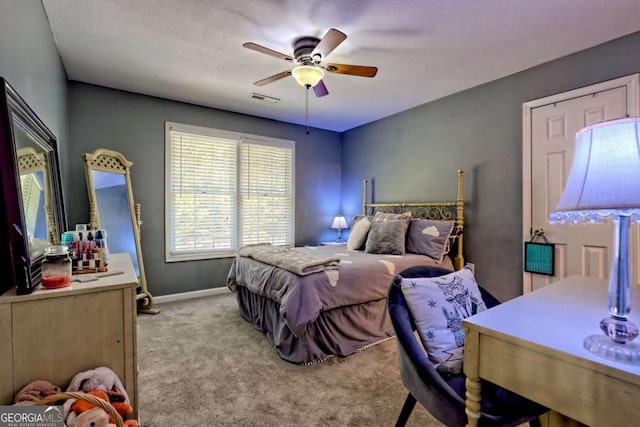 bedroom featuring visible vents, baseboards, carpet, and a ceiling fan