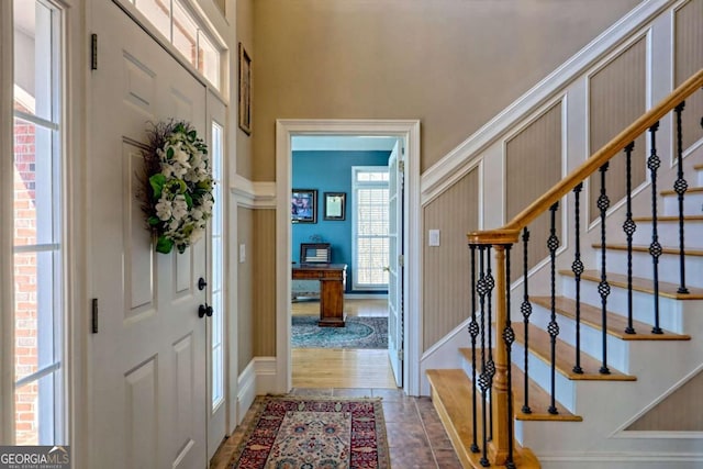 entrance foyer featuring stairs and a towering ceiling