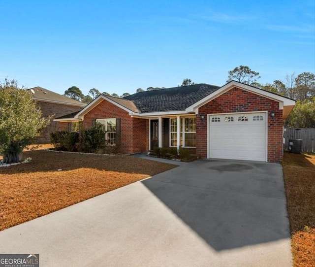 ranch-style home featuring brick siding, central air condition unit, an attached garage, and concrete driveway