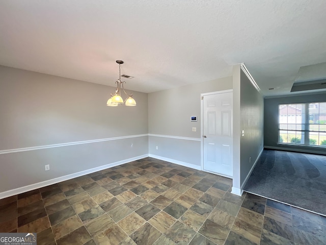 unfurnished room featuring stone finish floor, visible vents, and baseboards