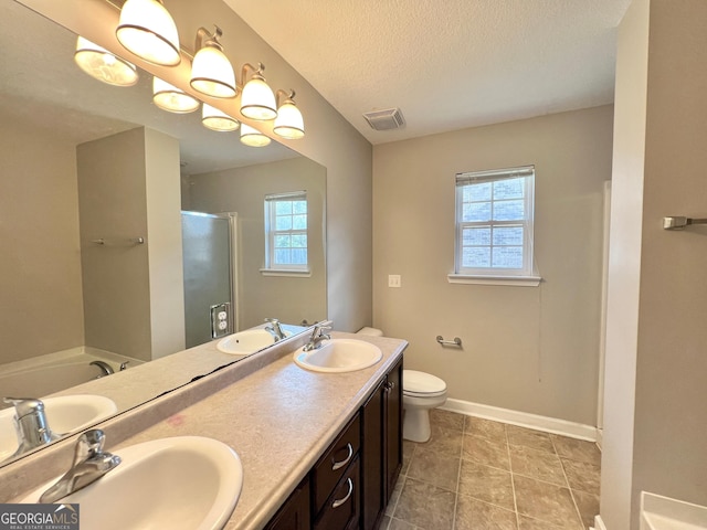 bathroom with a sink, visible vents, and plenty of natural light