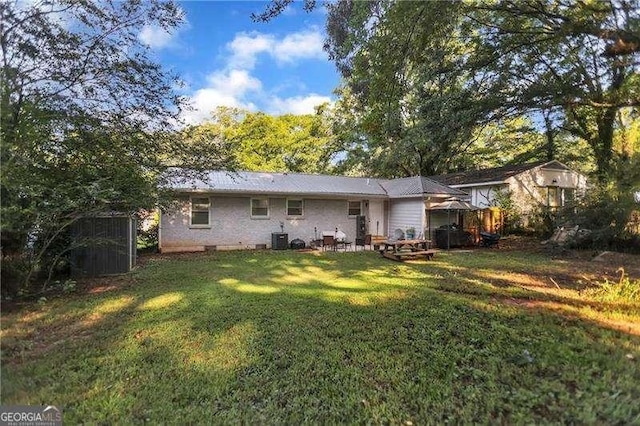 1824 Evans Dr SW, Atlanta, GA 30310 - rear view of house with an outbuilding, a lawn, cooling unit, and a storage shed