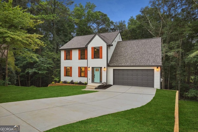 view of front facade with a front lawn, roof with shingles, concrete driveway, and an attached garage