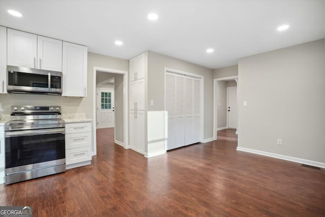 kitchen with dark wood finished floors, visible vents, recessed lighting, and stainless steel appliances