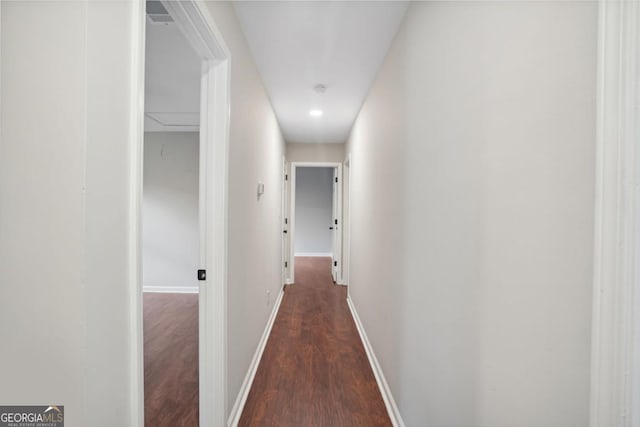 hall with wood finished floors and baseboards