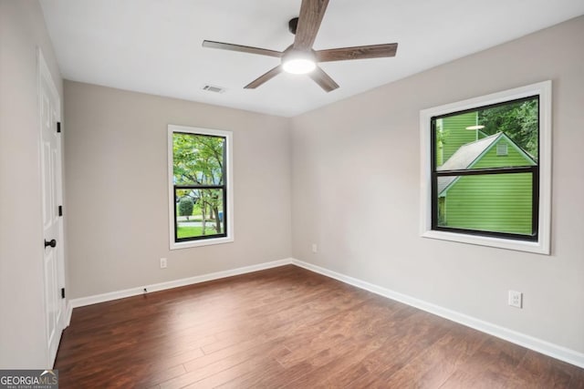 unfurnished room with baseboards, ceiling fan, and wood finished floors