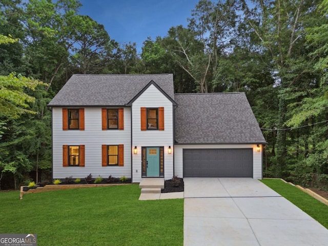 modern inspired farmhouse with a front yard, an attached garage, driveway, and roof with shingles