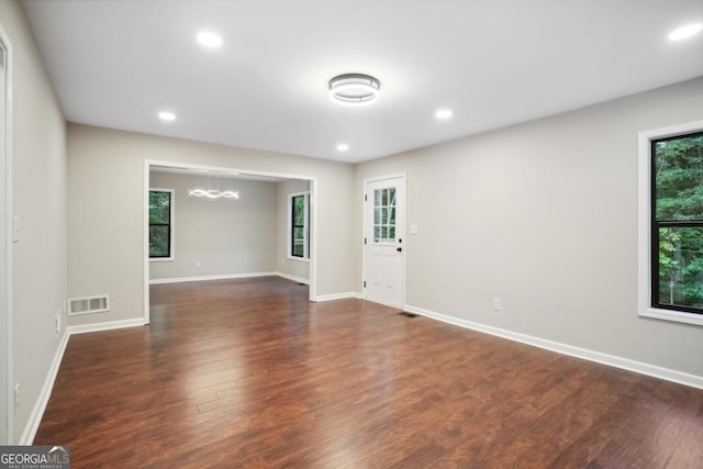 interior space with recessed lighting, dark wood-style floors, visible vents, and baseboards