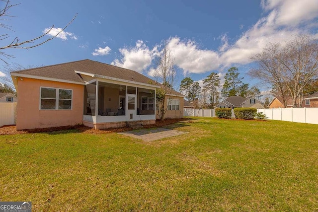 rear view of property with roof with shingles, a yard, a fenced backyard, a sunroom, and stucco siding