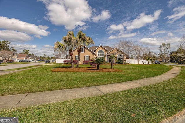 view of front of home with stucco siding and a front lawn