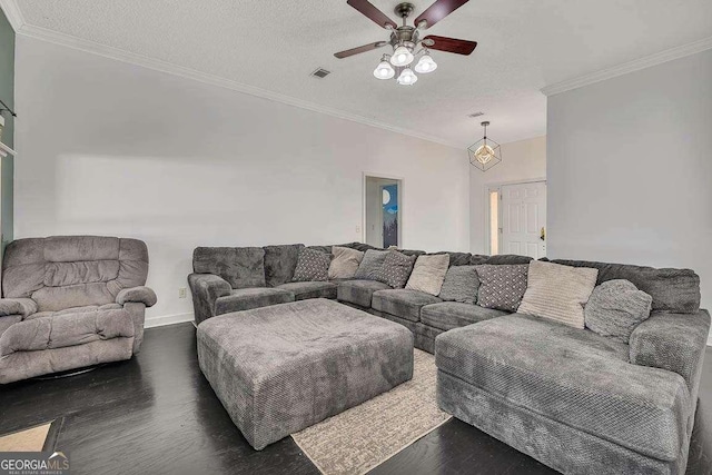 living area with visible vents, ornamental molding, a textured ceiling, a ceiling fan, and dark wood-style flooring