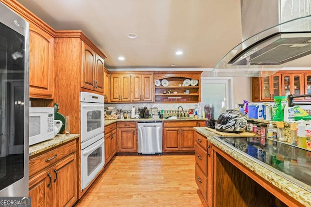 kitchen with open shelves, backsplash, range hood, white appliances, and brown cabinetry