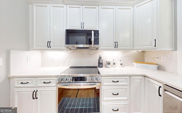 kitchen with white cabinetry, light countertops, tasteful backsplash, and appliances with stainless steel finishes