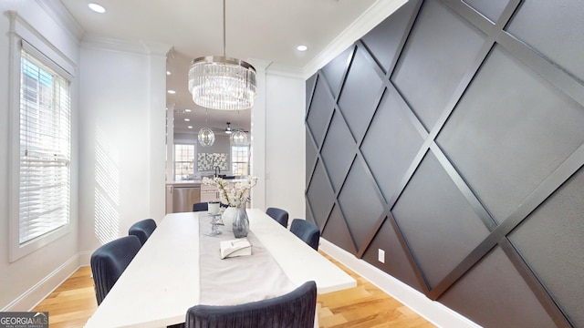 dining room featuring recessed lighting, light wood-type flooring, an inviting chandelier, and ornamental molding