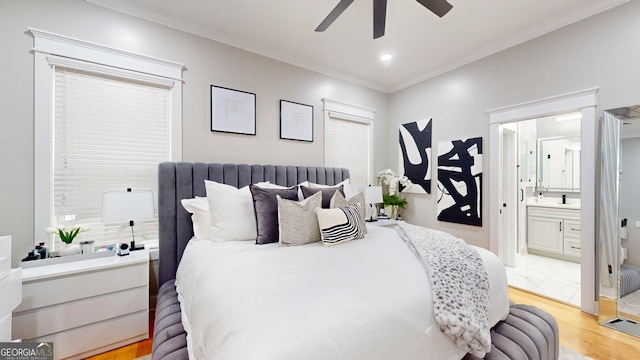 bedroom featuring a ceiling fan, light wood finished floors, ensuite bath, recessed lighting, and crown molding