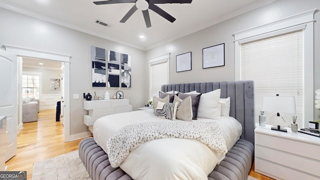 bedroom featuring visible vents, a ceiling fan, recessed lighting, light wood-style floors, and crown molding