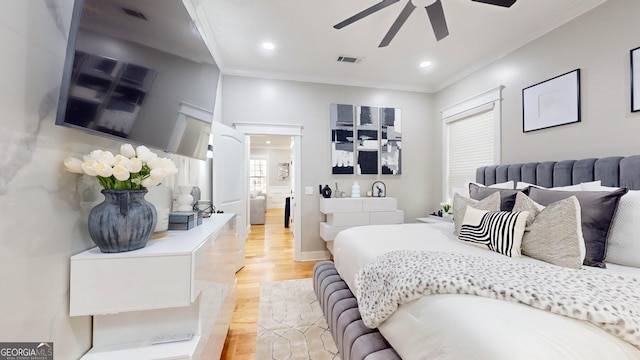 bedroom with crown molding, light wood-style flooring, recessed lighting, and visible vents