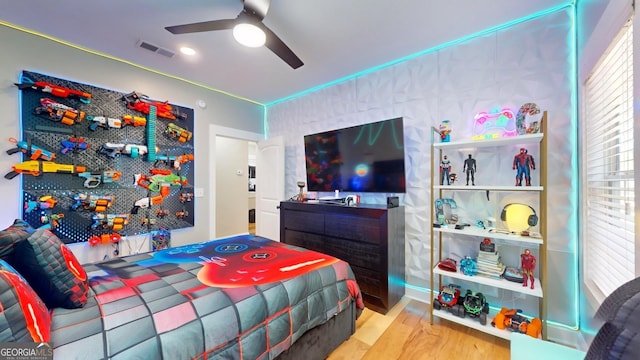 bedroom with visible vents, ceiling fan, and wood finished floors