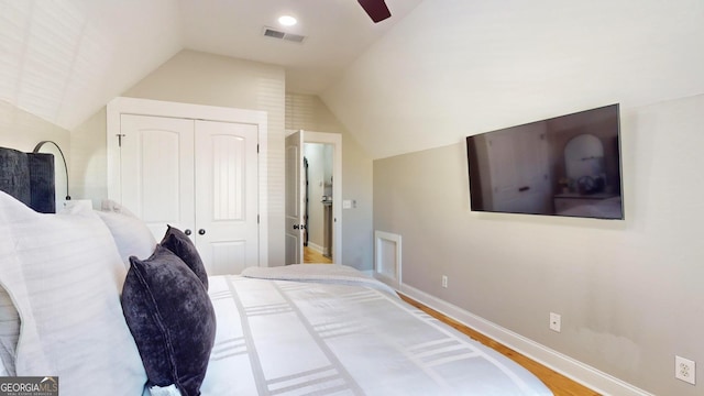 bedroom with visible vents, a ceiling fan, a closet, baseboards, and vaulted ceiling