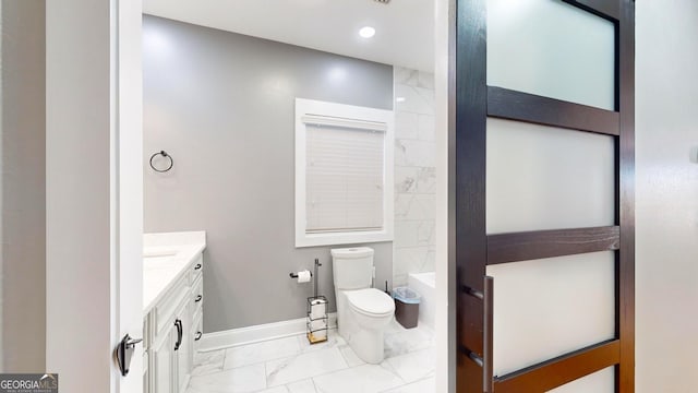 full bath featuring baseboards, toilet, recessed lighting, marble finish floor, and vanity