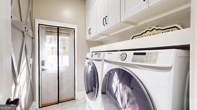 washroom featuring washer and dryer, baseboards, cabinet space, and marble finish floor