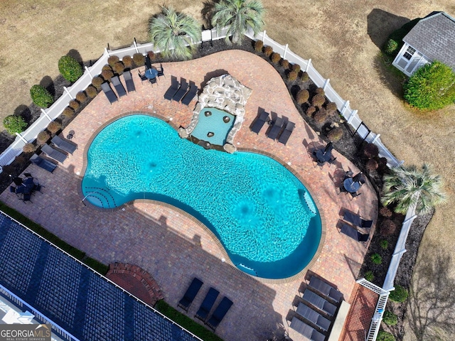 view of swimming pool with a patio area and fence