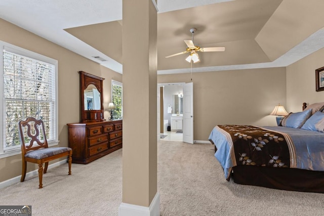 bedroom with visible vents, multiple windows, light colored carpet, and baseboards