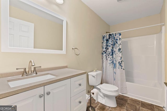 bathroom featuring vanity, toilet, and shower / bath combo with shower curtain