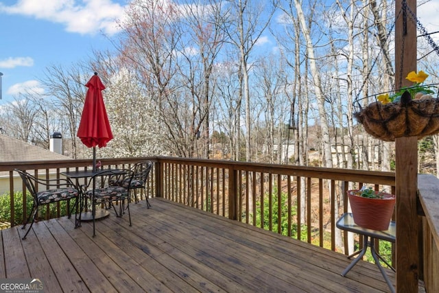 wooden terrace with outdoor dining area