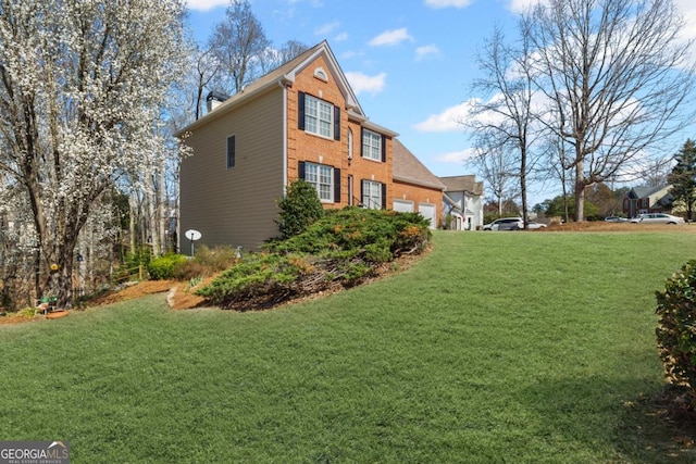 view of side of property with a yard, brick siding, and an attached garage