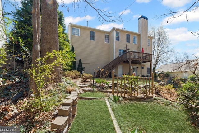 back of property featuring stairway, a lawn, a chimney, and a wooden deck