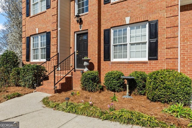 entrance to property with brick siding