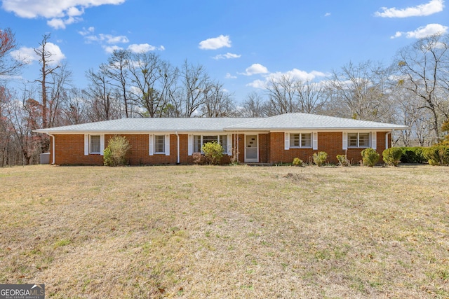 single story home with a front yard and brick siding