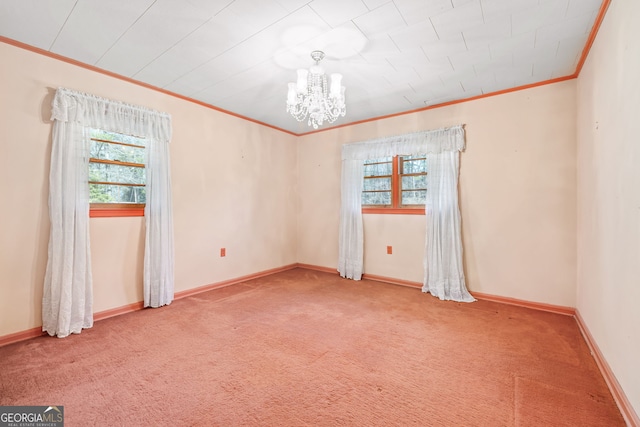 carpeted empty room featuring a healthy amount of sunlight, baseboards, an inviting chandelier, and ornamental molding