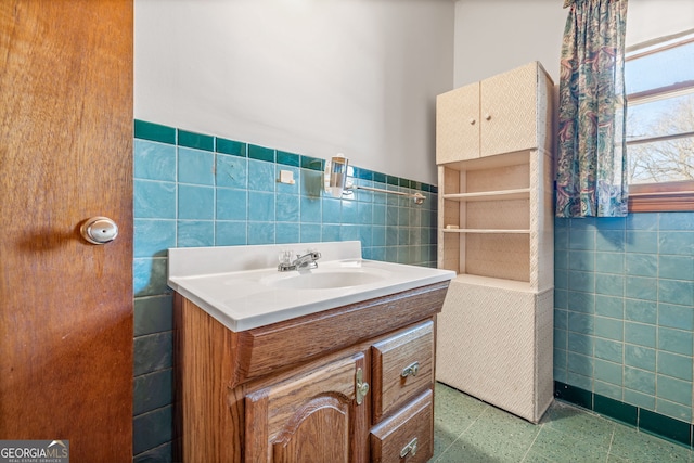 bathroom with vanity, tile walls, and wainscoting