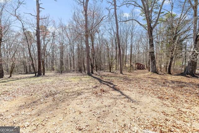 view of landscape featuring a wooded view