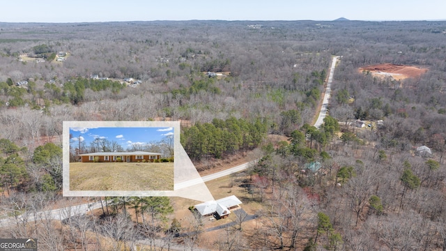 drone / aerial view featuring a forest view