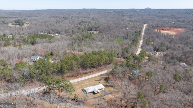 drone / aerial view with a wooded view