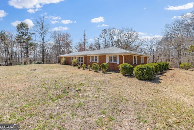 view of front of home with a front yard and brick siding