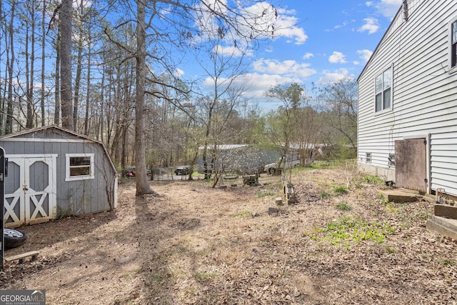 view of yard featuring an outbuilding and a shed