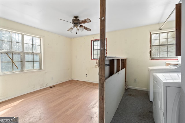 laundry area with visible vents, laundry area, wood finished floors, washer and dryer, and a ceiling fan